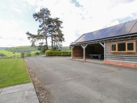 An outdoor area with a building and a view of hills at The Hayloft in Bleddfa near Knighton