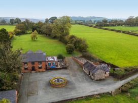 An outdoor view of a house with a garden and fountain at Ty Newydd in Llangadfan