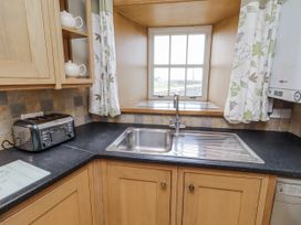 A kitchen with a sink and toaster at High Hemmel House in Embleton