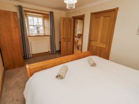 A bedroom with a bed and towels at High Hemmel House in Embleton