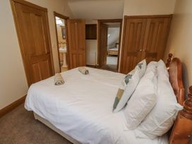A bedroom with a bed and towels at High Hemmel House in Embleton