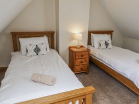 A bedroom with two single beds and a nightstand at High Hemmel House Embleton