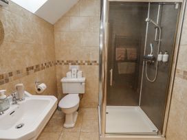 A bathroom with a sink, toilet, and shower at High Hemmel House in Embleton