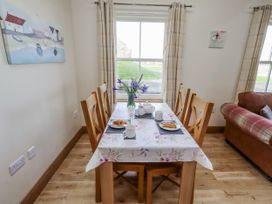 A dining room with a table set for tea at Home Stead Cottage in Embleton
