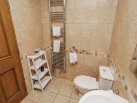 A bathroom with towel radiator and shelving at Home Stead Cottage in Embleton