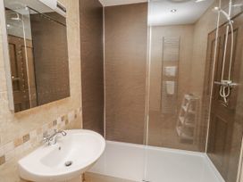 A bathroom with a sink and shower at Home Stead Cottage in Embleton