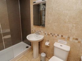 A bathroom with a shower, sink, and toilet at Home Stead Cottage in Embleton