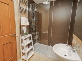 A bathroom with a shower and sink at Home Stead Cottage in Embleton