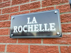 A nameplate labeled La Rochelle on a brick wall at La Rochelle Whitby