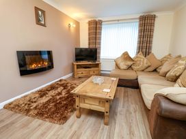 A living room with a fireplace and sofa at La Rochelle in Whitby