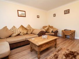 A living room with a sofa and coffee table at La Rochelle in Whitby