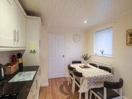 A kitchen with a dining table and chairs at La Rochelle in Whitby