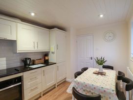 A kitchen with a table and chairs at La Rochelle in Whitby