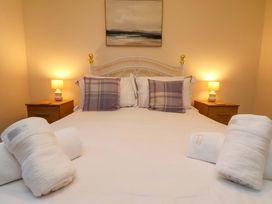A bedroom with a bed and bedside lamps at La Rochelle in Whitby