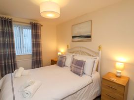 A bedroom with a bed and bedside tables at La Rochelle in Whitby