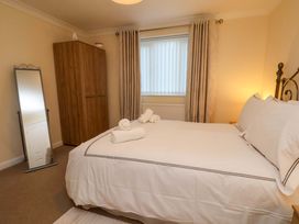 A bedroom with a double bed and wardrobe at La Rochelle in Whitby