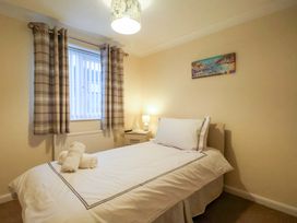A bedroom with a single bed and lamp at La Rochelle in Whitby
