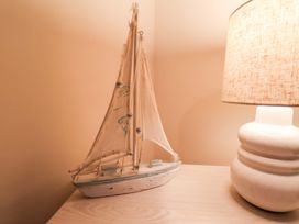 A boat model and a lamp on a table at La Rochelle in Whitby