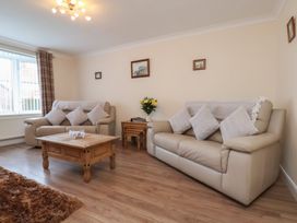 A living room with two sofas and a coffee table at La Rochelle in Whitby