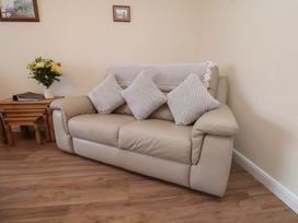 A sofa with cushions and a coffee table in a living room at La Rochelle in Whitby