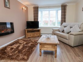 A living room with a sofa and coffee table at La Rochelle in Whitby