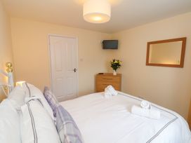 A bedroom with a bed and a television at La Rochelle in Whitby