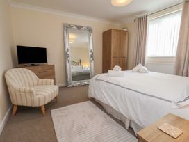 A bedroom with a bed and mirror at La Rochelle in Whitby