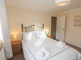 A bedroom with a bed and nightstand at La Rochelle in Whitby