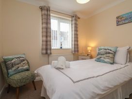 A bedroom with a bed and chair at La Rochelle in Whitby