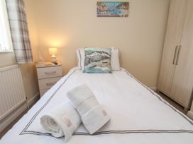 A bedroom with a bed and towels on top at La Rochelle in Whitby