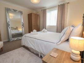 A bedroom with a bed and mirror at La Rochelle in Whitby