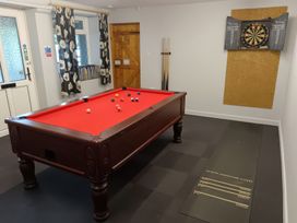 A game room with a pool table and a darts board at Kingfisher in Blaenwaun