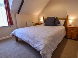 A bedroom with a bed and bedside tables at Kingfisher in Blaenwaun