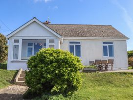 A house with a garden and outdoor seating at Highdown in Bigbury on Sea near Modbury