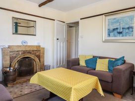 A living room with a fireplace and sofa at Highdown Bigbury on Sea near Modbury