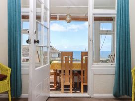 A dining room with a view of the sea at Highdown Bigbury on Sea near Modbury