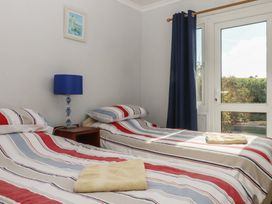 A bedroom with two beds and a window at Highdown Bigbury on Sea near Modbury