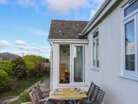 An outdoor dining area with a table and chairs at Highdown Bigbury on Sea near Modbury