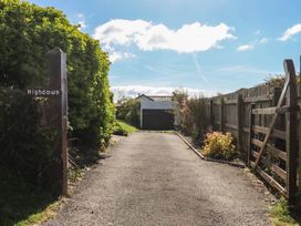A driveway with a sign and gate at Highdown in Bigbury on Sea near Modbury