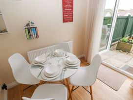 A dining area with a table and chairs at Sandyhill House in Saundersfoot