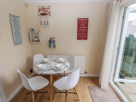 A dining room with a table set for dinner at Sandyhill House in Saundersfoot
