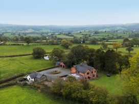 A farmhouse with garden and pond at Bwthyn Ty Newydd in Llangadfan