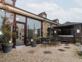An outdoor area with a table and chairs next to a gazebo at Seacrest Lodge in Scarborough