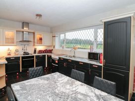 A kitchen with a sink, oven, and table at Seacrest Lodge in Scarborough