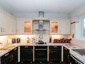 A kitchen with cabinets, stove and kettles at Seacrest Lodge in Scarborough