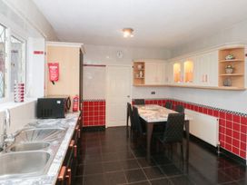 A kitchen with a dining table and cabinets at Seacrest Lodge in Scarborough