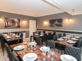 A dining room with multiple tables set for a meal at Seacrest Lodge in Scarborough