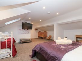A bedroom with a bed and crib at Seacrest Lodge Scarborough