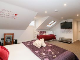 A bedroom with a bed and sofa bed at Seacrest Lodge in Scarborough