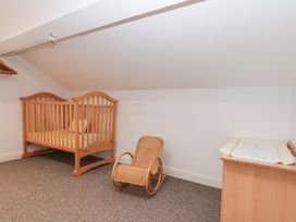 A nursery with a crib and a rocking chair at Seacrest Lodge Scarborough